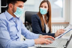 Workers at work while wearing masks.